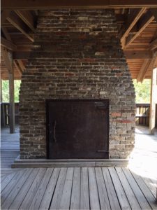 Chimney and door to feed in iron ore, charcoal and limestone. 